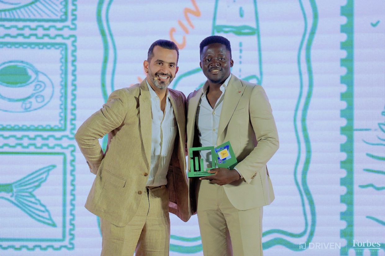 Umar receiving an award at a Driven | Forbes Global Properties event